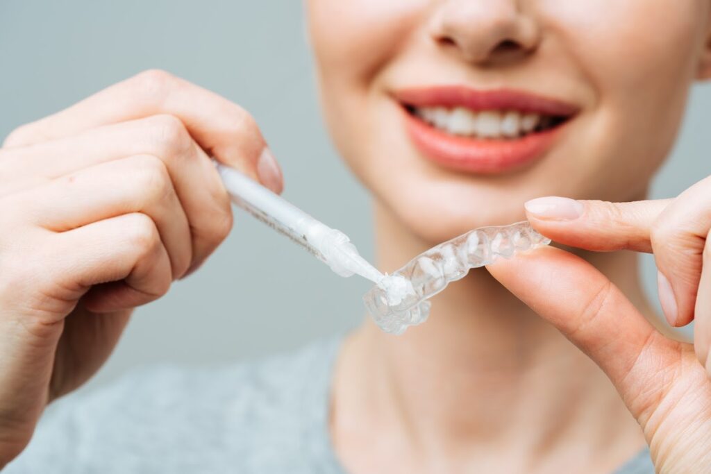 A woman preparing a home teeth whitening procedure