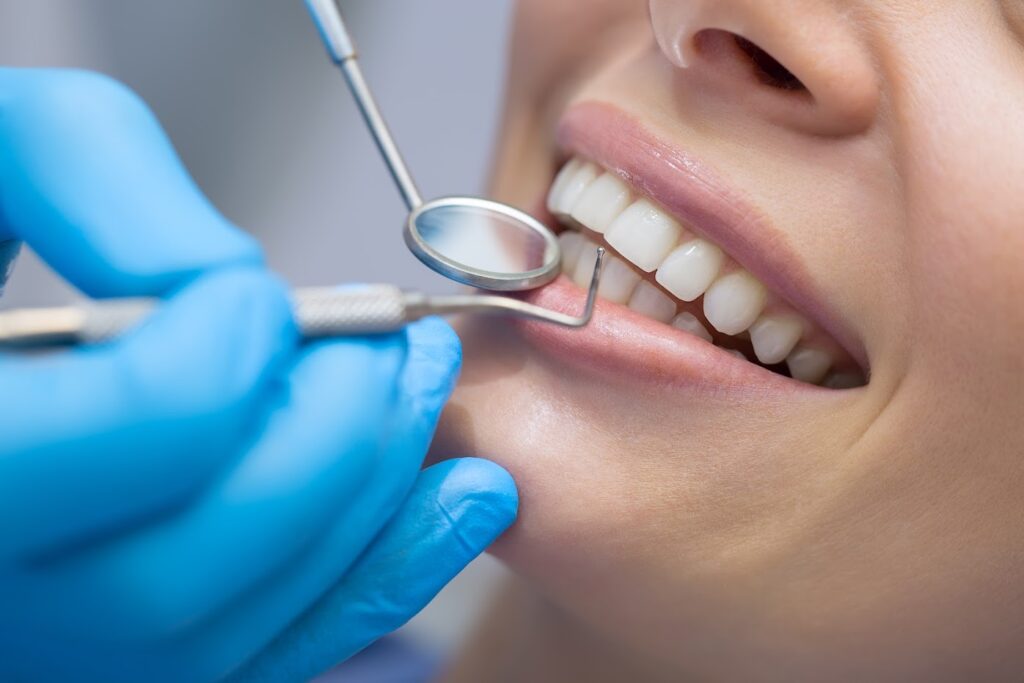 A woman smiling and dental supplies 