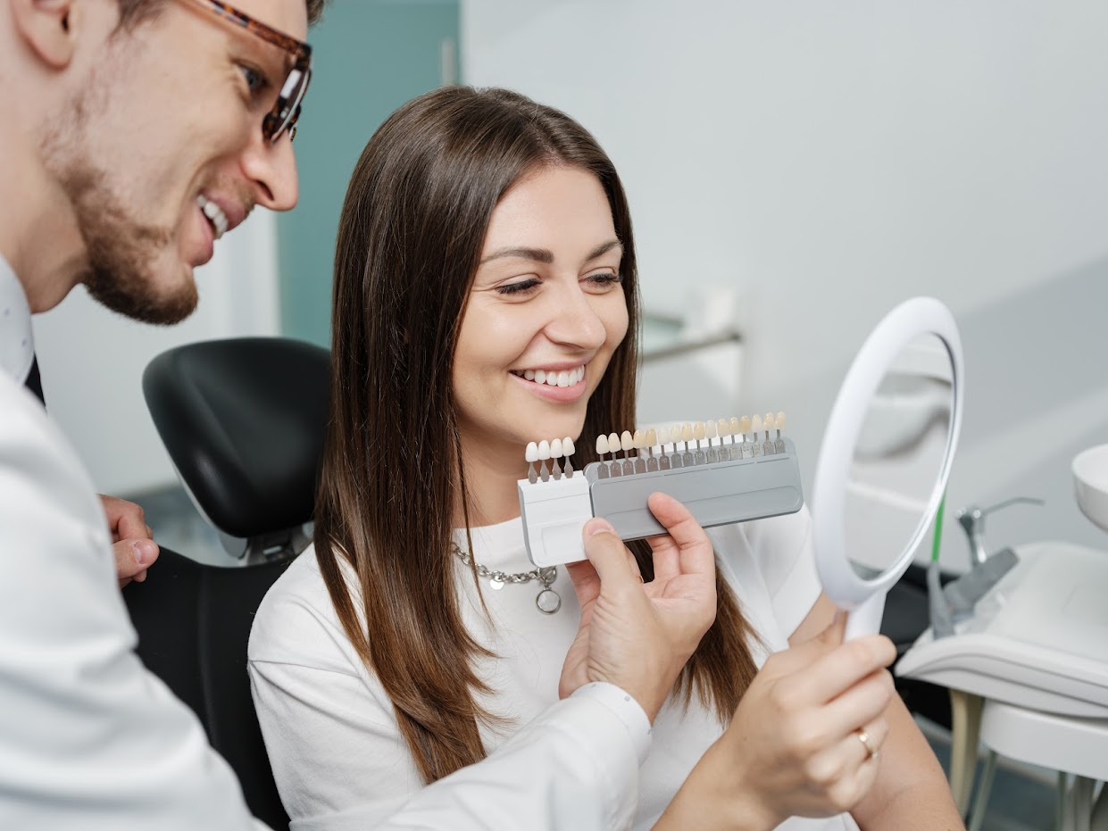 Dentist showing a veneer palette to a patient